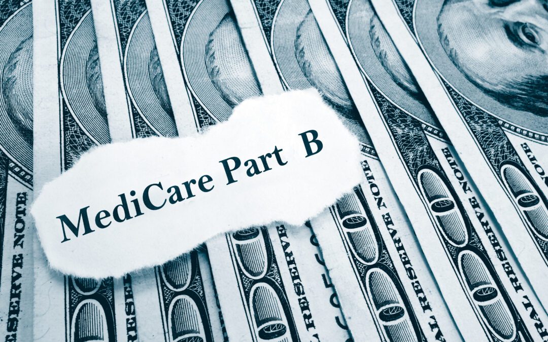 A torn piece of white paper with the text "Medicare Part B" lying on top of U.S. dollar bills.
